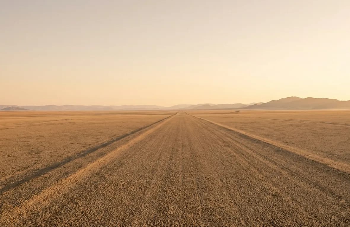 Desert road stretching into the Namibian landscape
